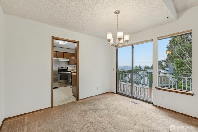 empty room featuring visible vents, baseboards, a chandelier, light colored carpet, and a textured ceiling