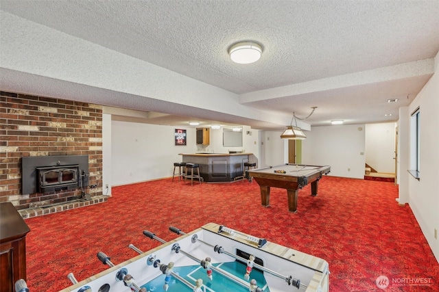 game room with baseboards, carpet floors, a textured ceiling, and a bar