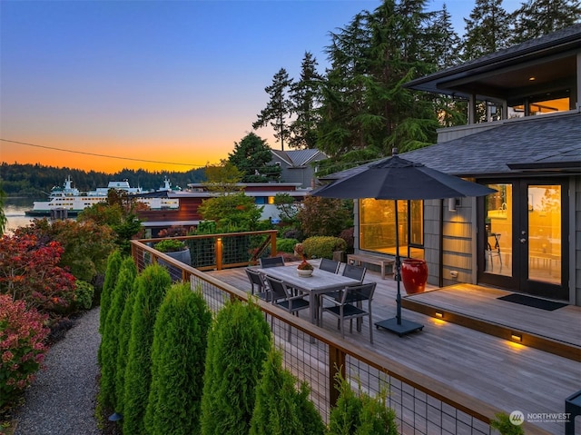 wooden terrace with french doors and outdoor dining space