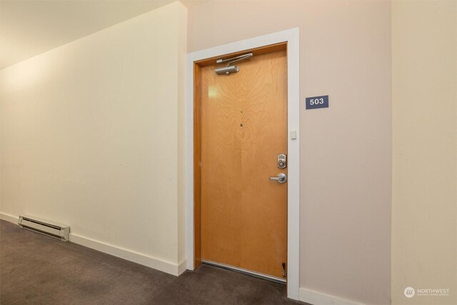 doorway to property with a baseboard radiator