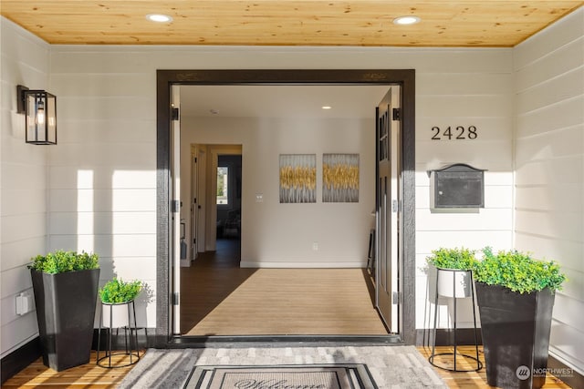 corridor with wooden ceiling and hardwood / wood-style flooring