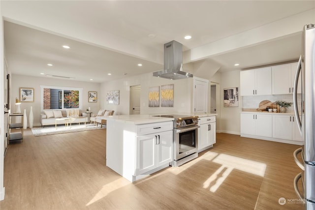 kitchen with white cabinets, appliances with stainless steel finishes, decorative backsplash, and exhaust hood