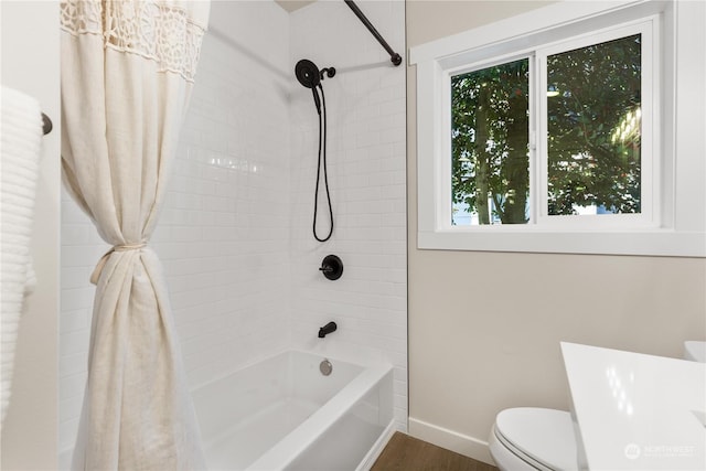 bathroom featuring shower / tub combo with curtain, hardwood / wood-style floors, and toilet