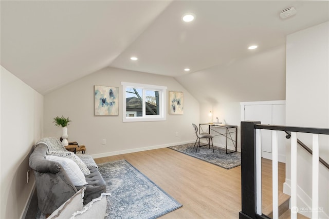 living area with light wood-type flooring and lofted ceiling