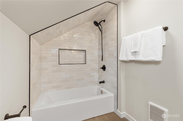 bathroom featuring hardwood / wood-style flooring and tub / shower combination