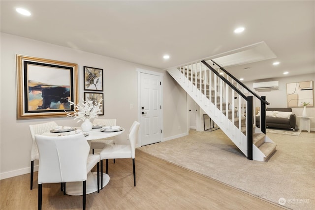 carpeted dining space featuring an AC wall unit