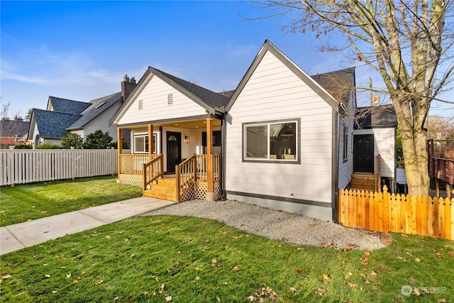 bungalow-style home featuring a front yard and covered porch