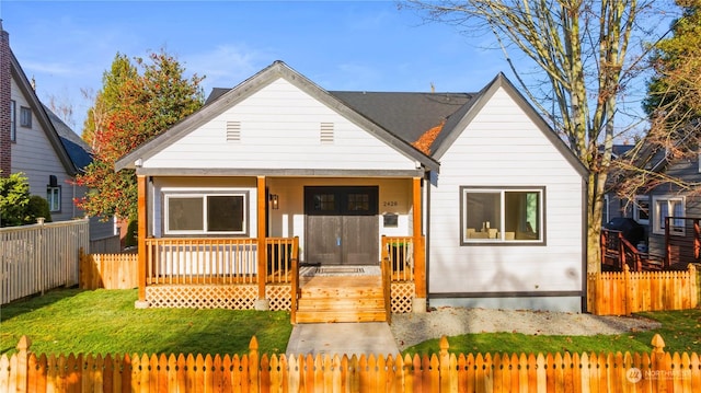 bungalow-style house featuring a front lawn and a porch