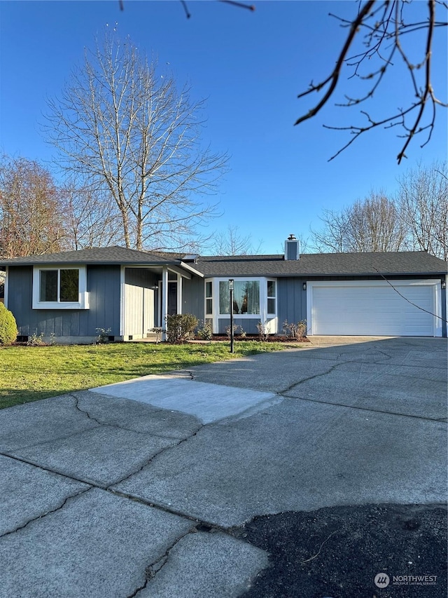 ranch-style home with a front lawn and a garage