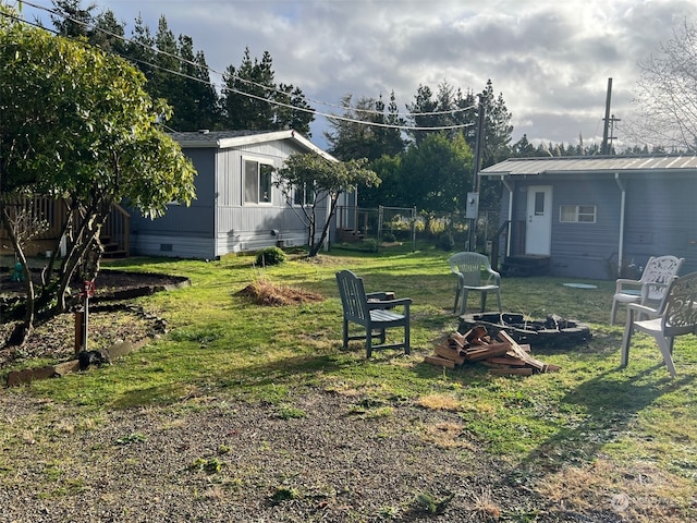 view of yard with an outdoor fire pit