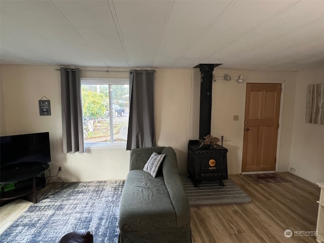 living room with hardwood / wood-style flooring and a wood stove