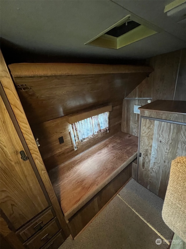 stairs featuring wood walls