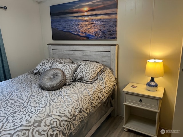 bedroom with dark hardwood / wood-style flooring