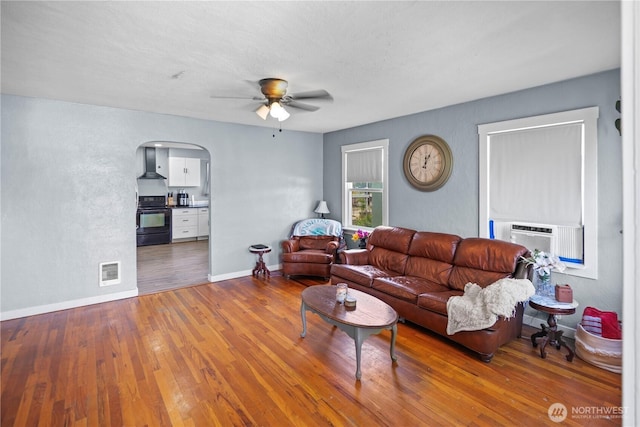 423 3rd Ave NE, Soap Lake, WA 98851 - living area featuring ceiling fan, wood finished floors, arched walkways, baseboards, and a textured wall