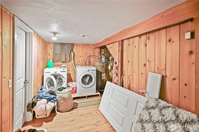 423 3rd Ave NE, Soap Lake, WA 98851 - washroom with water heater, separate washer and dryer, wood finished floors, wood walls, and a textured ceiling
