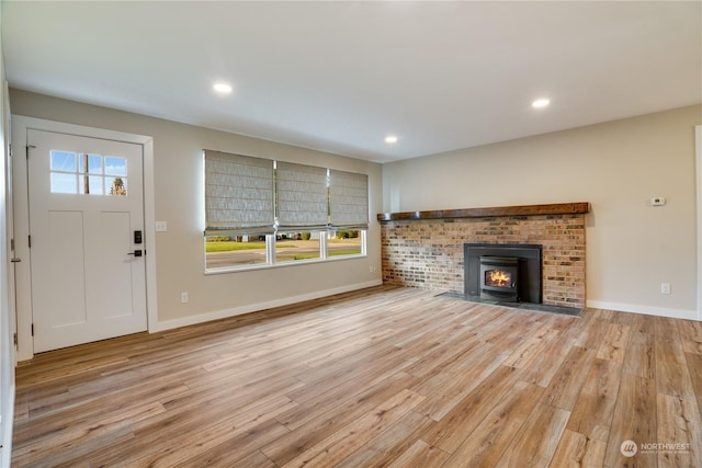 unfurnished living room featuring plenty of natural light and light wood-type flooring