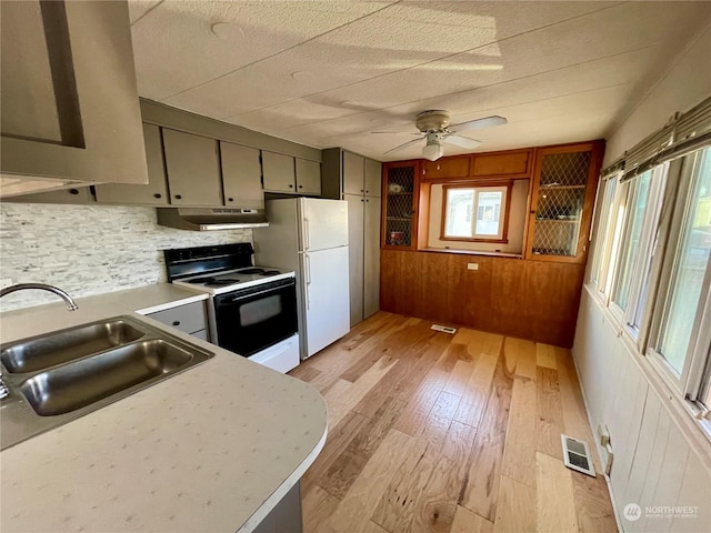 kitchen with white appliances, sink, decorative backsplash, ceiling fan, and light wood-type flooring