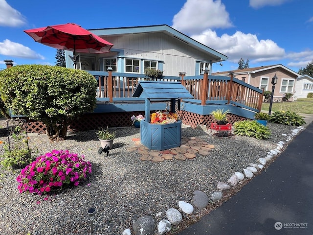 rear view of house featuring a wooden deck