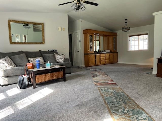 carpeted living room featuring ceiling fan with notable chandelier and lofted ceiling