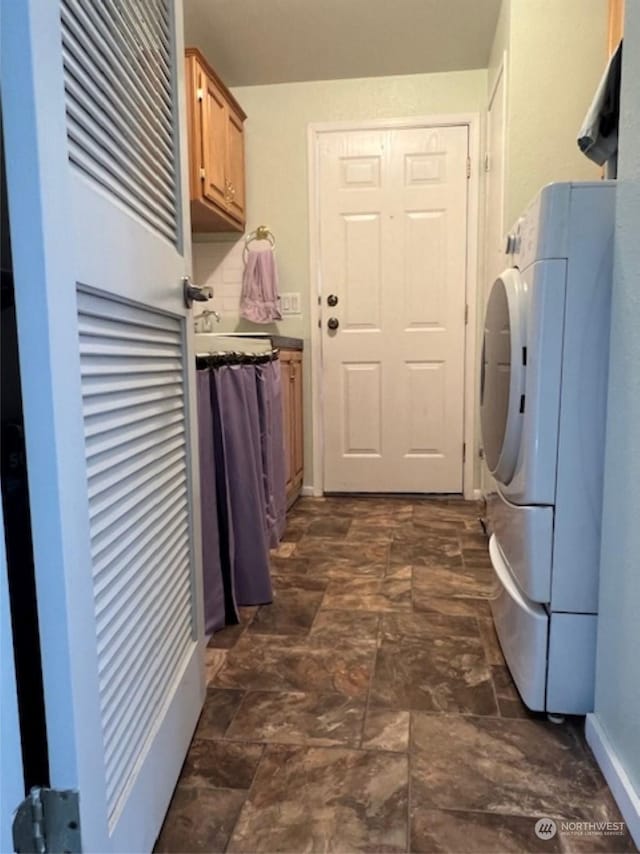 washroom with cabinets and washer / dryer