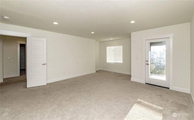 unfurnished room featuring light carpet, baseboards, and recessed lighting