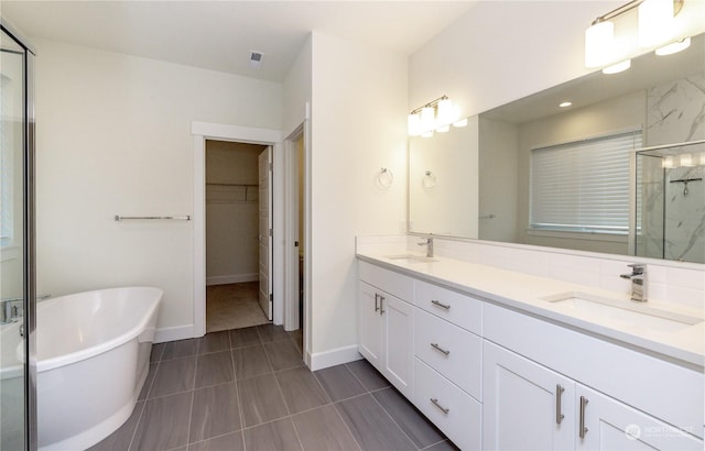 bathroom with tile patterned floors, vanity, and independent shower and bath