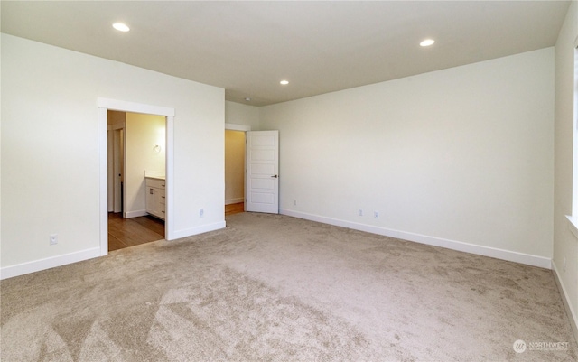 unfurnished bedroom featuring carpet floors, recessed lighting, connected bathroom, and baseboards