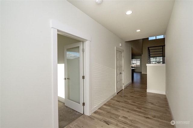 corridor with recessed lighting, baseboards, and wood finished floors