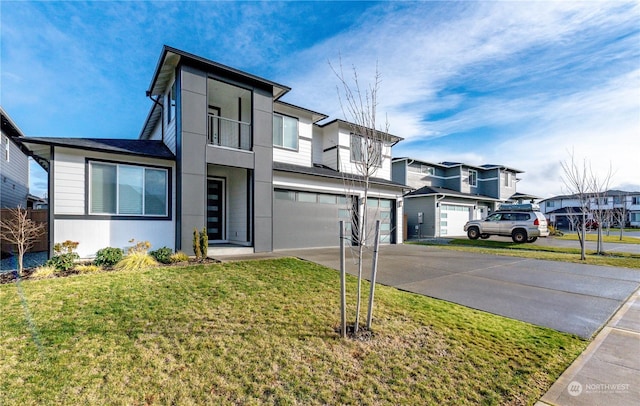 view of front facade with a garage, driveway, a residential view, a front yard, and stucco siding