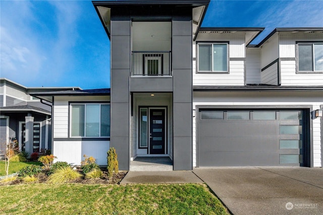 view of front of house with concrete driveway and an attached garage