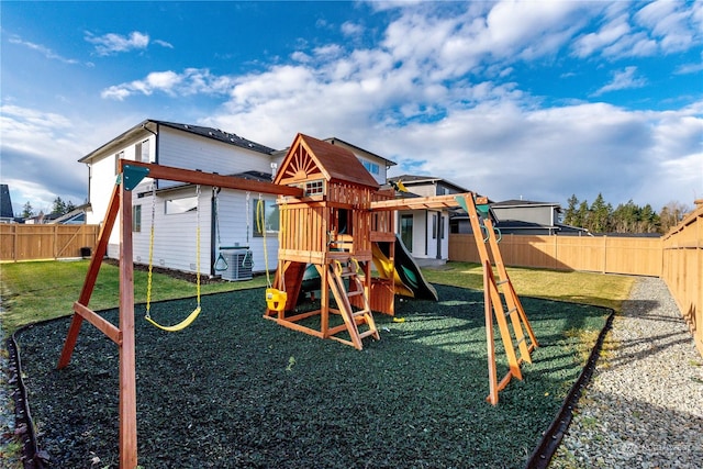 view of jungle gym featuring central air condition unit, a fenced backyard, and a yard