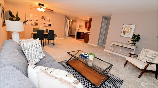 carpeted living room featuring ceiling fan