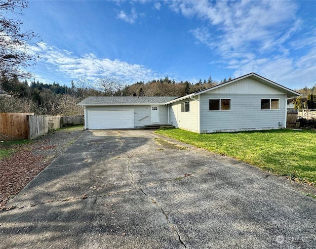 ranch-style house with a garage and a front lawn