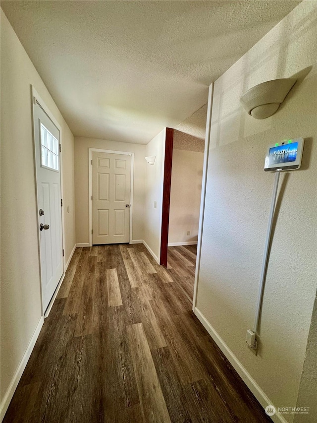 entrance foyer with hardwood / wood-style flooring and a textured ceiling