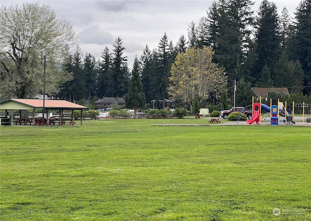 surrounding community with a lawn and a playground