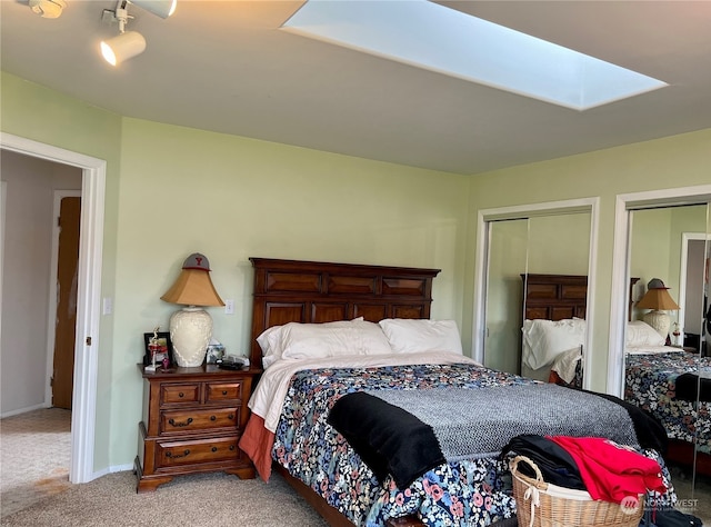 bedroom with light carpet and a skylight