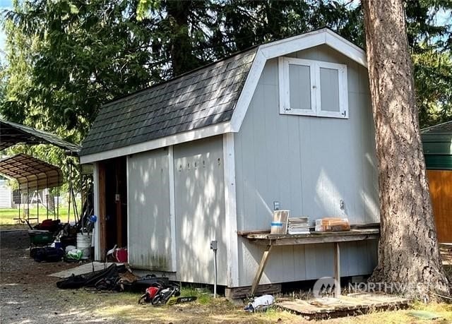 view of outbuilding with a carport