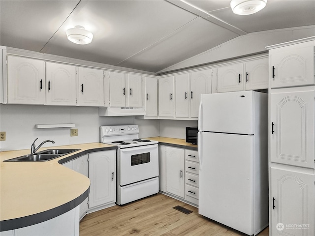 kitchen featuring vaulted ceiling, white cabinetry, and white appliances