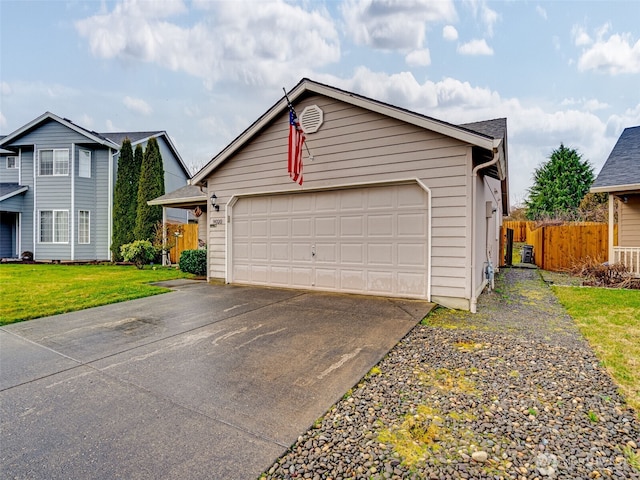 view of front of property featuring a garage, a front yard, and fence