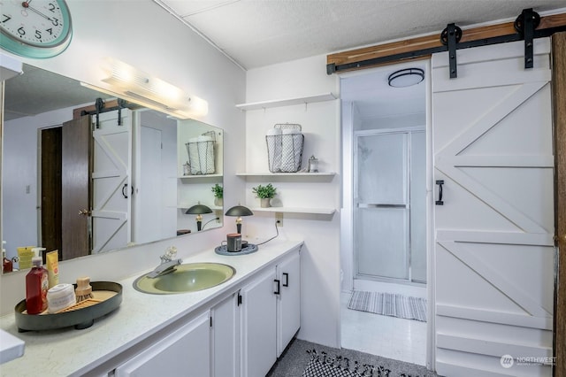 bathroom featuring vanity, a textured ceiling, and walk in shower