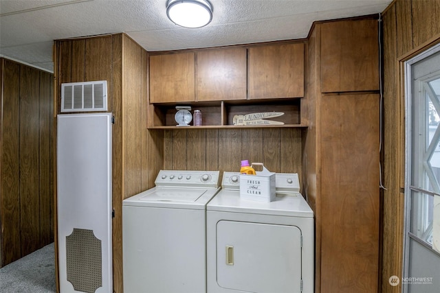 laundry area with washer and dryer, carpet flooring, and wood walls