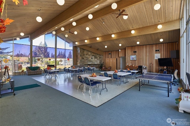 recreation room featuring ceiling fan, beam ceiling, high vaulted ceiling, a wall of windows, and wooden ceiling