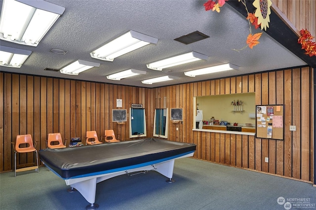 playroom featuring wood walls, a textured ceiling, and billiards