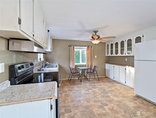 kitchen featuring ceiling fan, sink, white cabinets, white fridge, and black / electric stove