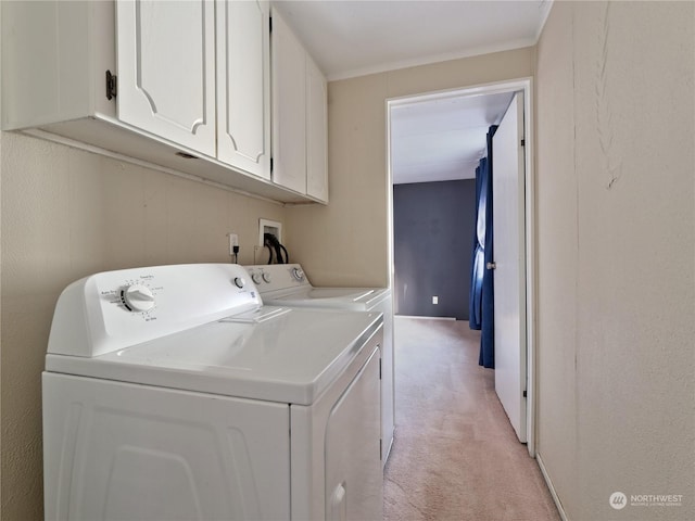 washroom with crown molding, cabinets, independent washer and dryer, and light carpet