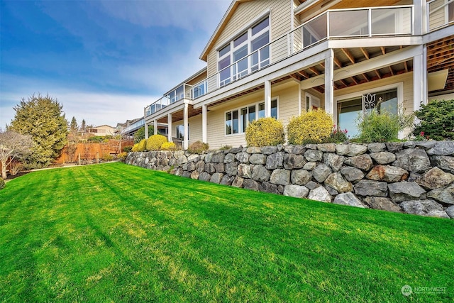 view of side of home with a yard