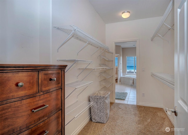 walk in closet featuring light tile patterned flooring