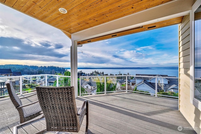 wooden terrace featuring a water view