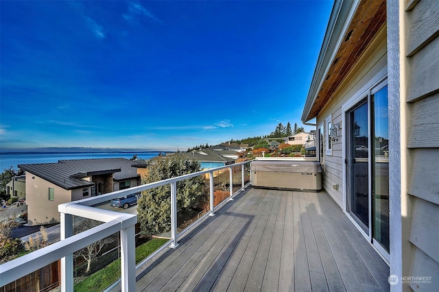 wooden terrace featuring a water view