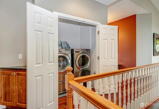 laundry area with washing machine and dryer and wood-type flooring